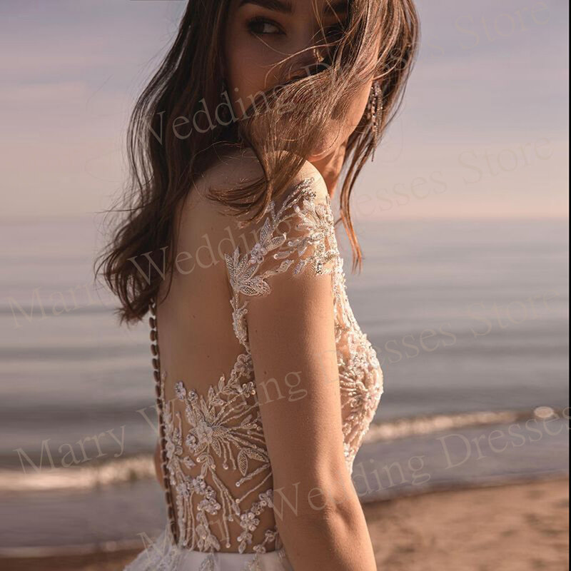 Moda fascynująca linia suknie ślubne nowe aplikacje z krótkim rękawem cekinowe suknie panny młodej iluzja tiudos Novias Boda