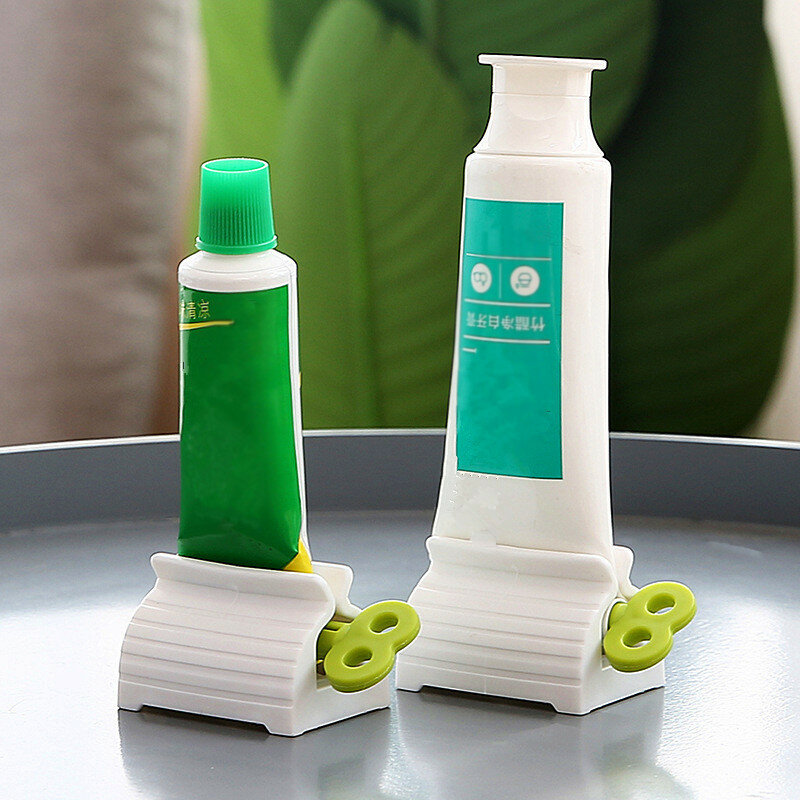 Moda nova casa de plástico creme dental tubo squeezer fácil dispenser titular rolamento acessórios limpeza do dente banheiro fornecimento