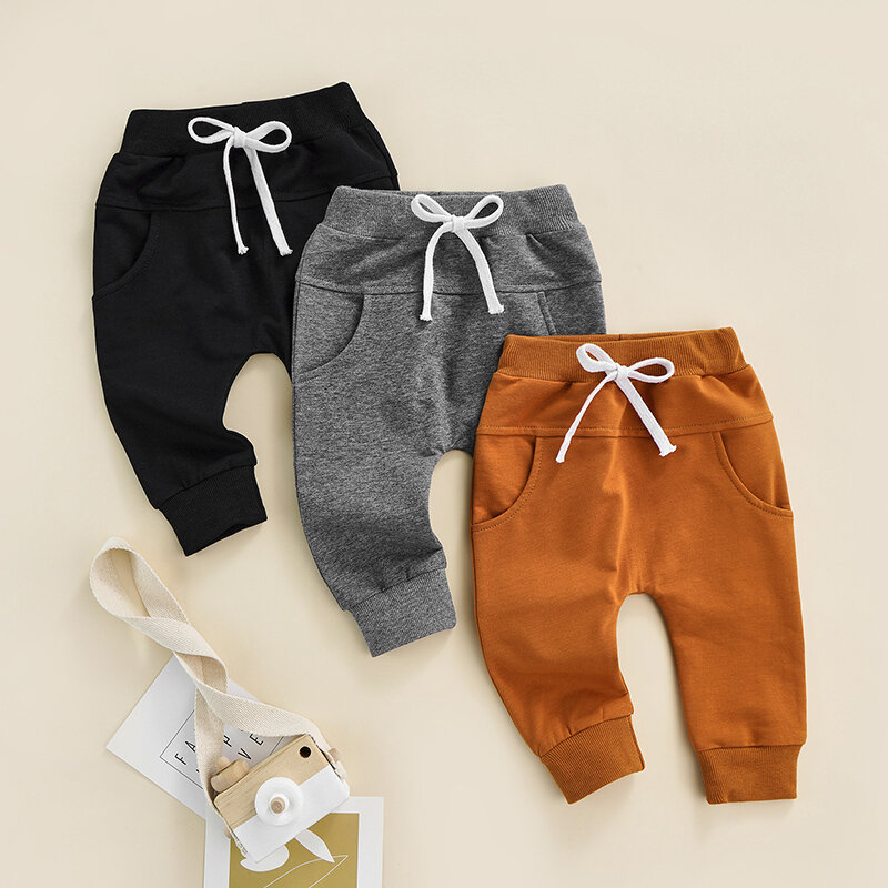 Dziecko spodnie dla chłopców i dziewcząt noworodka elastyczna talia regulowany sznurek jednolity kolor Casual luźny krój długie spodnie dla 0-3-lat
