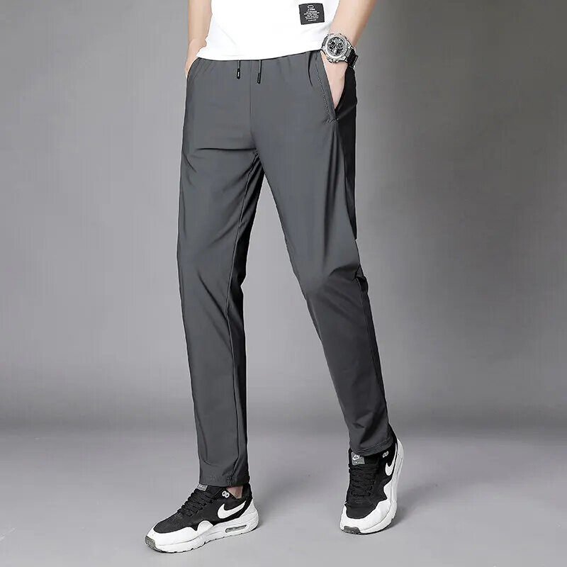 Celana olahraga pria, kasual trendi warna Solid saku elastis musim semi Slim Fit es sutra bernapas 2024