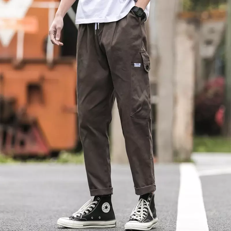 Hip-hopowe kombinezony męskie Harajuku haremowe spodnie Street Casual spodnie do joggingu kieszonkowe sznurowane nogawki męskie spodnie M-5XL