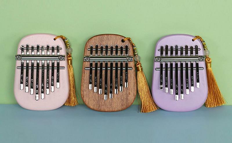 Piano de pulgar Kalimba para niños, Mini instrumento de dedo portátil, instrumentos decorativos bonitos con cordón para principiantes, 8 teclas