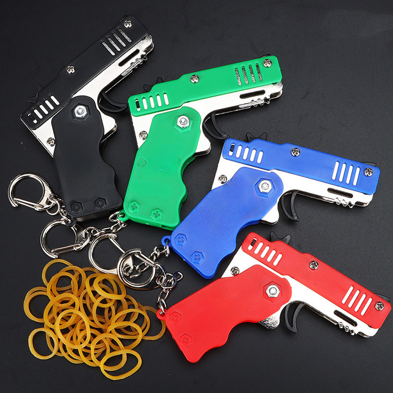 1pcs Mini Metal Gun Folding Rubber Band Toy Outdoor Sports Keychain Toy 6 Bursts Pistola de Borracha Kids Presentes Party Favor Gun Brinquedos