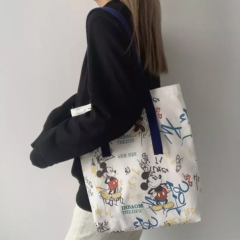 Disney ผ้าใบลายการ์ตูนกระเป๋าผู้หญิงไหล่เดี่ยวใหม่กระเป๋ากระเป๋า Mickey กระเป๋า Tote นักเรียน Graffiti ความจุขนาดใหญ่กระเป๋าถือขนาดเล็ก