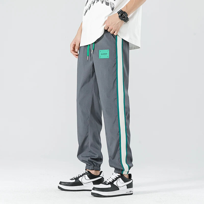 Calça de perna larga listrada lateral masculina, esporte casual casual e reto, versão coreana, corrida ao ar livre elegante, hip-hop, 2024