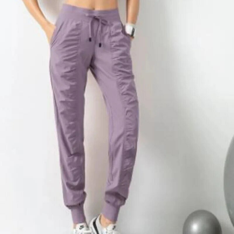 Pantalones deportivos de secado rápido para mujer con dos bolsillos laterales