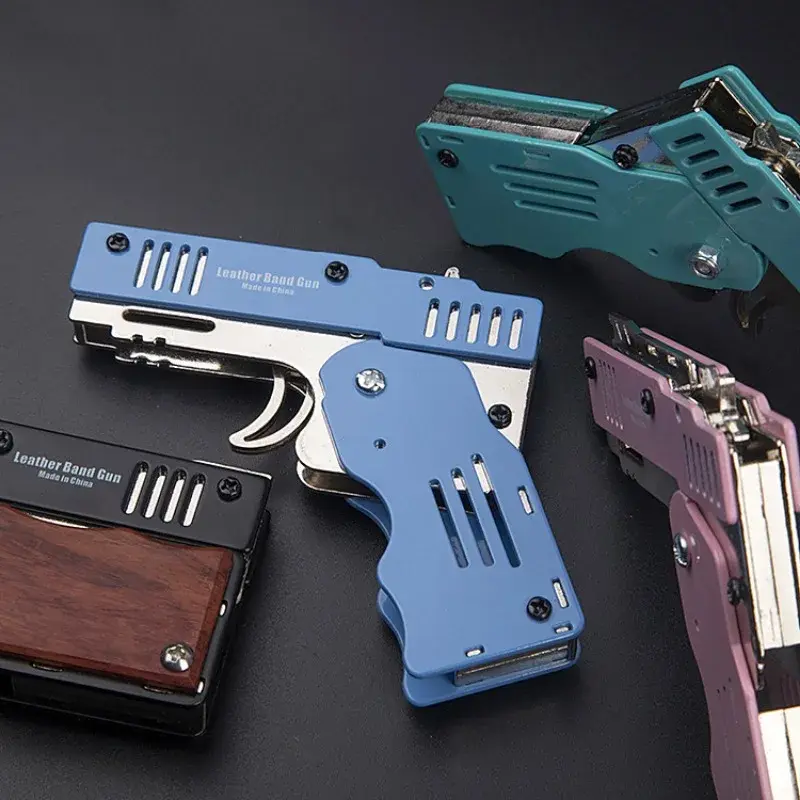 ปืนยางรัดแบบพับได้ของเล่นเด็กปืนพกยางรัดหกนัดทำจากโลหะจี้พวงกุญแจเด็กชายปืนกระสุนอ่อน