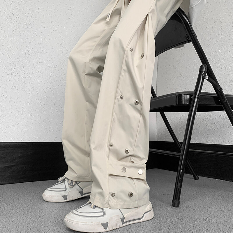 Bojówki męskie modne młodzieńcze popularne letnie z guzikami wzorem w jednolitym kolorze Streetwear w amerykańskim stylu luźne spodnie szyk