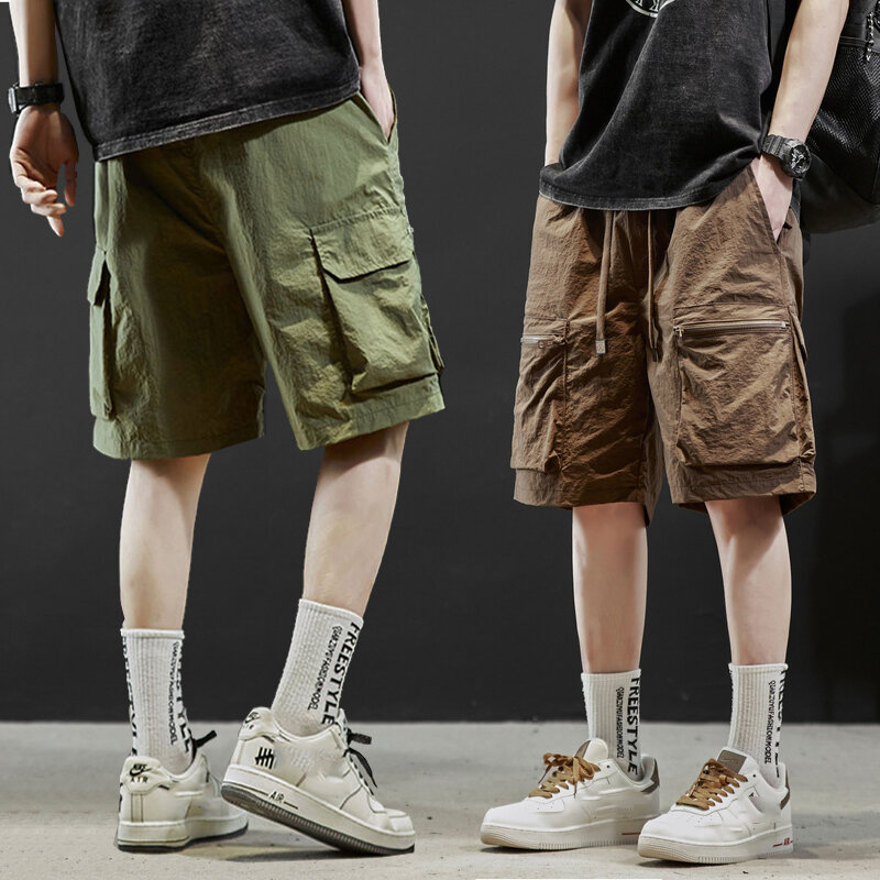 Letnie nowe męskie luźne spodenki wielofunkcyjne kieszenie w jednolitym kolorze sznurek spodnie do joggingu modnych wszechstronnych spodnie robocze