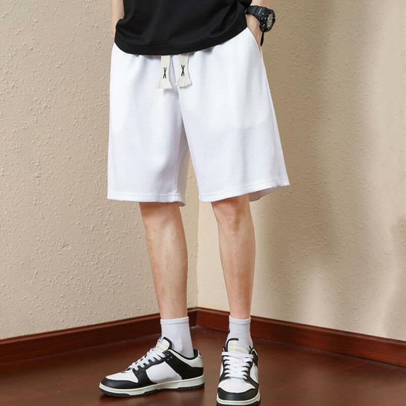 Celana pendek atletik serbaguna pria, celana pendek atletik musim panas dengan kantong pinggang elastis warna polos untuk Streetwear