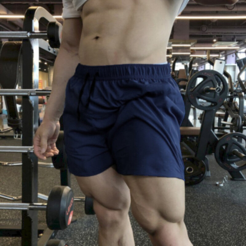 Celana pendek pria, celana boxer lari luar ruangan pinggang elastis kaki panjang penyerap kelembapan