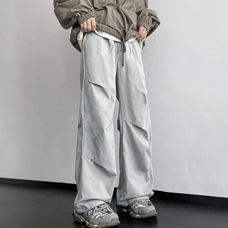 Sweatpants luar ruangan celana kargo Unisex bergaya dengan dekorasi keling longgar lebar pas desain tahan air untuk Streetwear atau luar ruangan