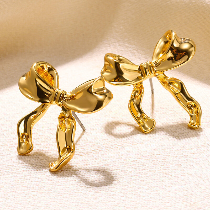 Женские серьги-гвоздики золотого цвета, с бантом