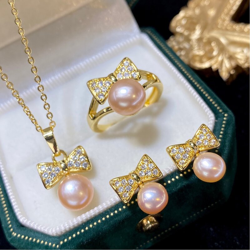 Un juego de pendientes de perlas de agua dulce rosa, 6-8mm, anillo de circón, colgante de bowknot