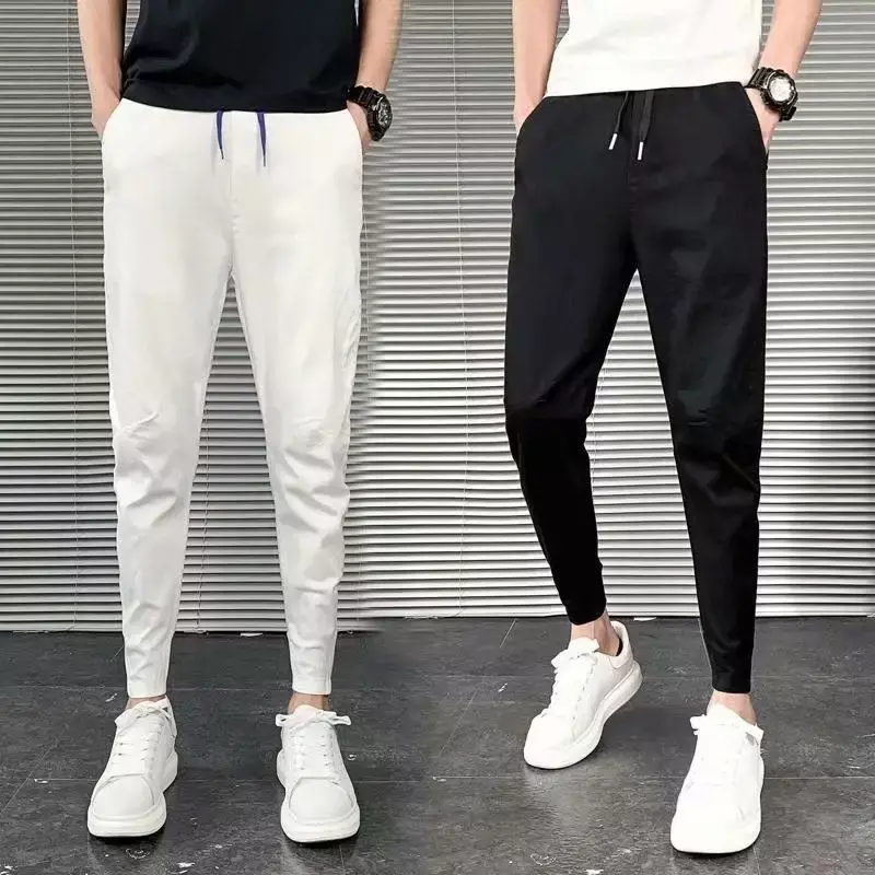 Koreańska moda Slim Fit męskie legginsy nowe letnie wysokiej wiązanie w pasie kieszonkowe czarne odzież męska do spodni w jednolitym kolorze