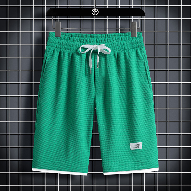 Pantalones cortos minimalistas de verano para hombre, cintura elástica, bolsillos con cordón, estilo fino, sueltos hasta la rodilla, informales