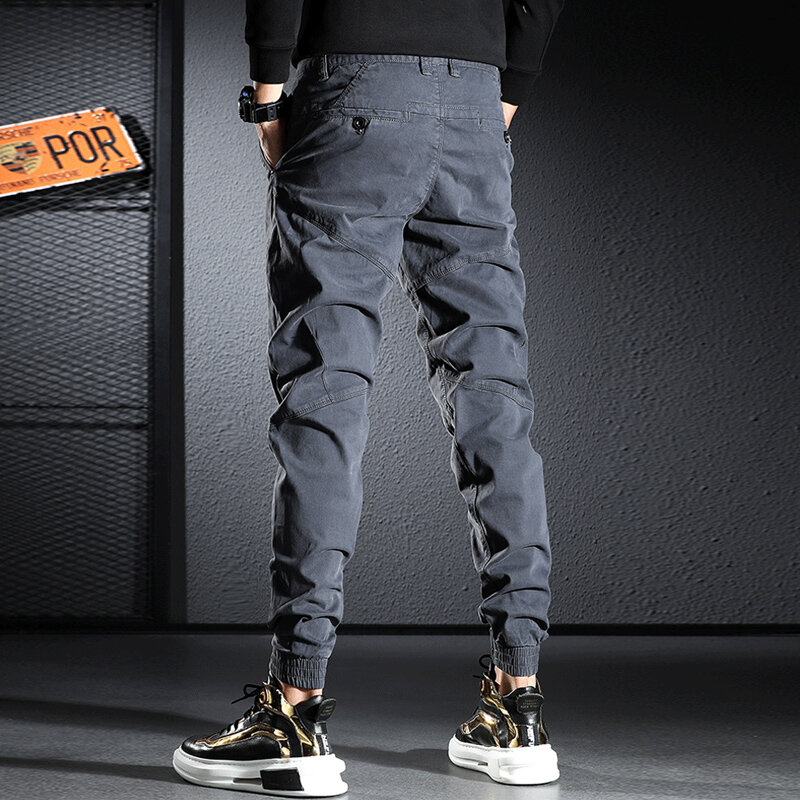 Streetwear moda masculina jeans elástico fino ajuste calças emendadas designer casual carga calças hombre hip hop corredores macacão