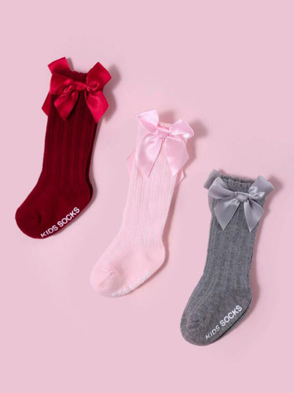 3 par/lote bebé medias largo calcetines para niños y niñas Unisex arcos de no Skid español caliente lindo calcetín alto con puños