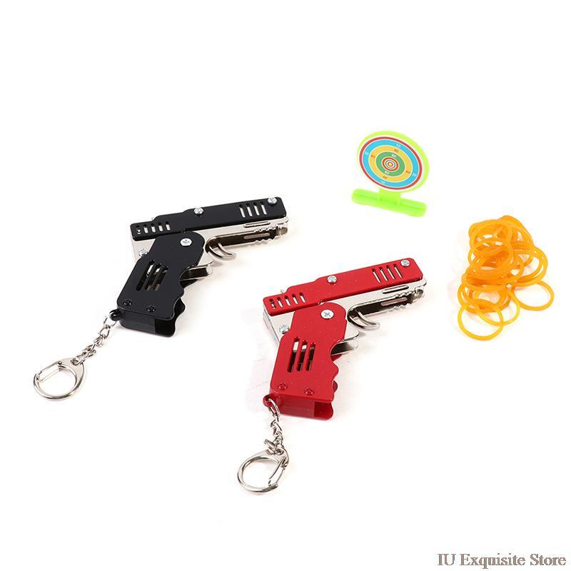 1 juego completo de pistola de Metal con banda de goma, modelo de pistola de juguete plegable, pistola de juguete de seis ráfagas, regalo para escuela primaria, juego de animación, llavero