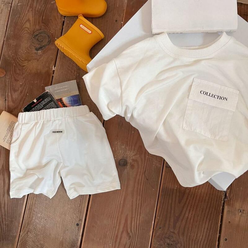 Verão 0-6-year-old meninos e meninas simples carta manga curta terno bebê algodão grande bolso topo camiseta curto casual