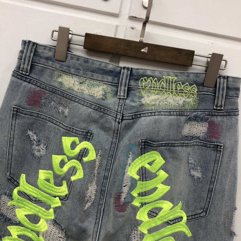 Pantalones vaqueros desgastados con agujeros para hombre y mujer, ropa de calle de la mejor calidad, negro, verde, fluorescente, bordado de letras